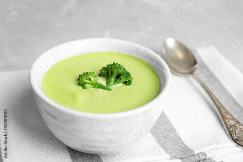 Delicious broccoli cream soup served on table
