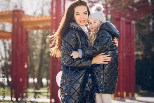 Fashionable mother with daughter. Family in a spring park. Mother's day © prostooleh