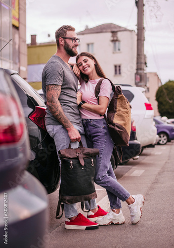 Stylish hipster couple in love, swag outfit, jeans, embrace, cool accessories, vintage style