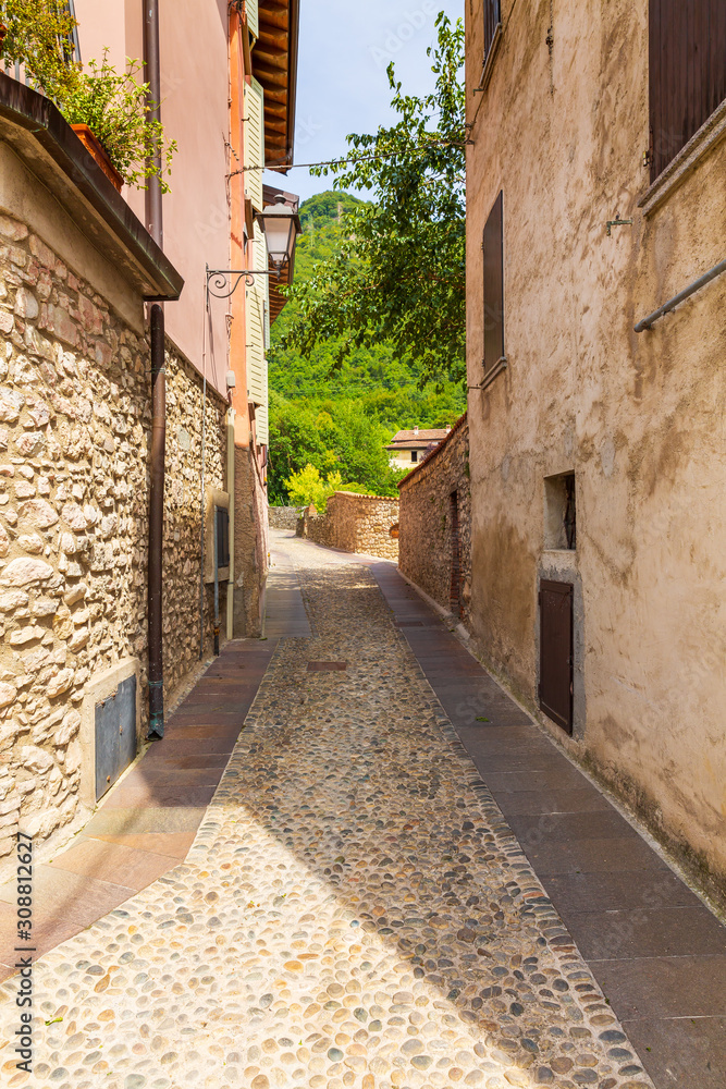 Fototapeta premium Old village street view, narrow alley, old architexcture and touristic landmark at Renzano near Salo, Italy