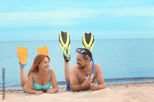 Happy couple on beach with ...