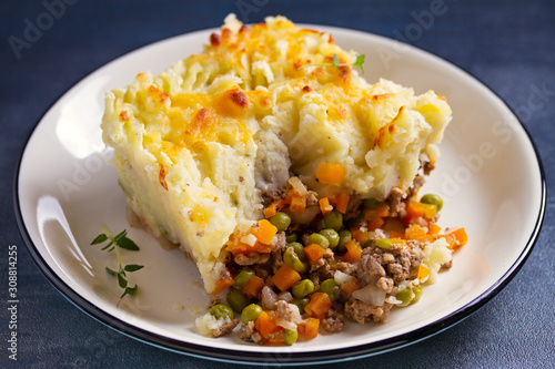 Shepherd's Pie or Cottage Pie on plate, gray backgroud. Horizontal image