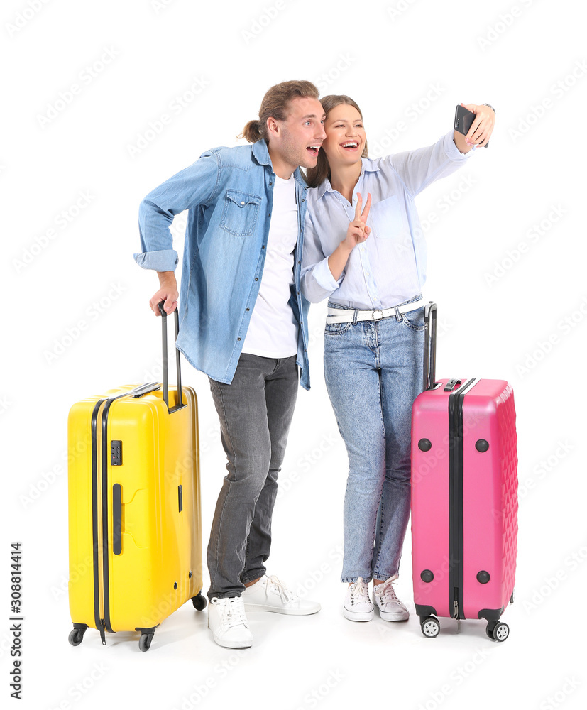 Young couple with suitcases taking selfie on white background Young couple with suitcases taking selfie on white background