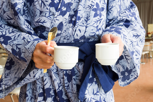 Photography tokyo, japan, 09/22/2019 , Japanese woman wearing yukata, holding two coffee mug