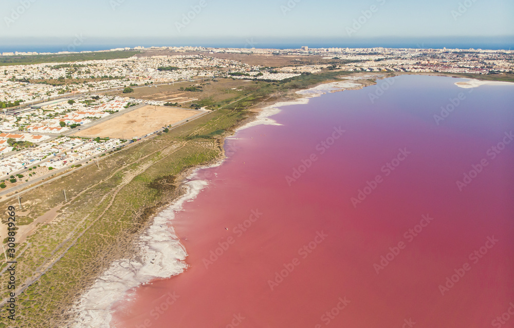 Beautiful aerial wide vibrant summer view of las Salinas de Torrevieja, The Pink Lake Of Torrevieja, pink salt lagoon in Torrevieja, Costa Blanca, province of Alicante, Spain