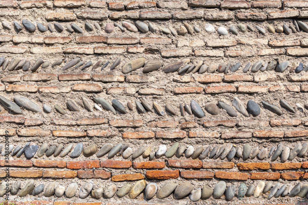 Old fortress wall built of bricks and river stones Old fortress wall built of bricks and river stones