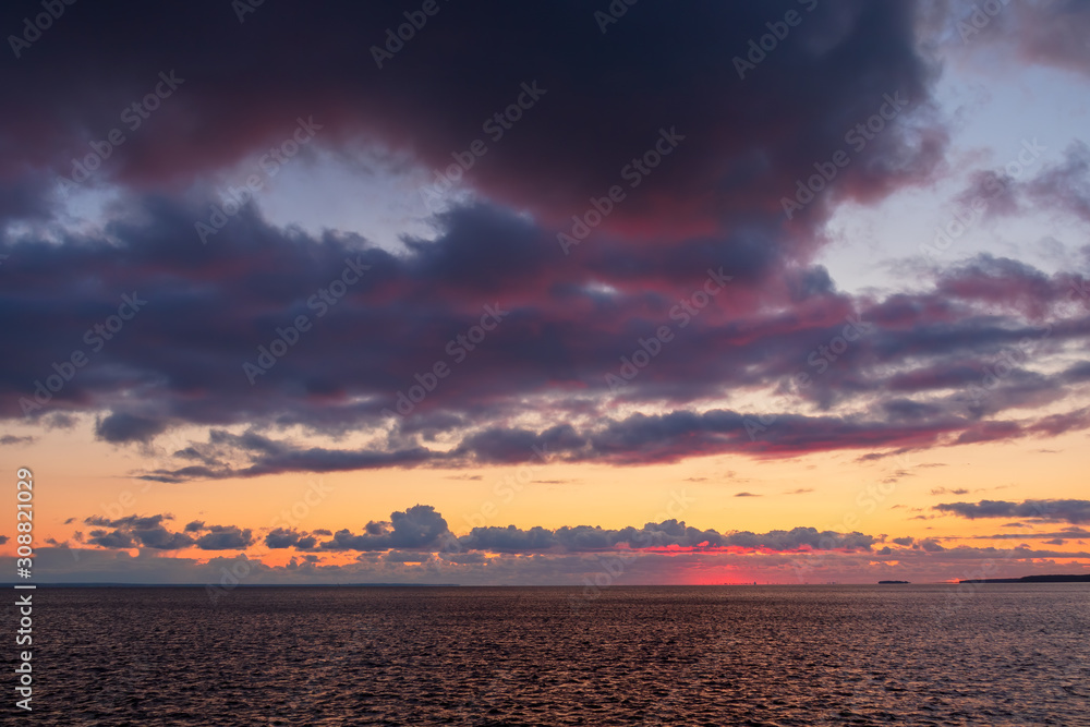 Beautiful sunset seascape. Sea view and clouds at sunset. Great for background.