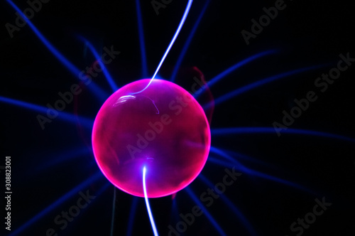 ball with electric neon pulses on a dark background, blur, selective focus