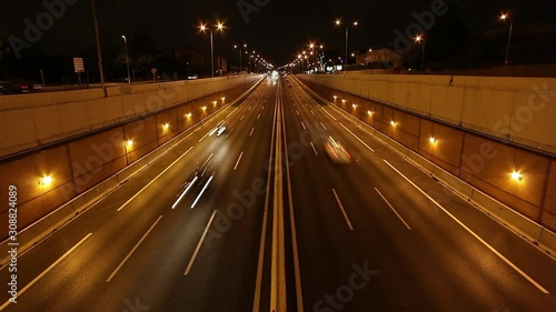 time lapse highway at night engraved from the top of a tunnel entrance
