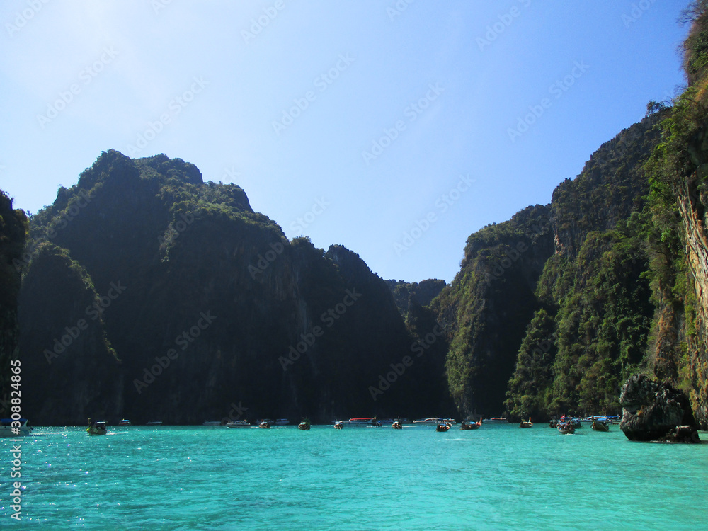 Beautiful limestone carvings off shore from Krabi with blue green water, Krabi, Thailand