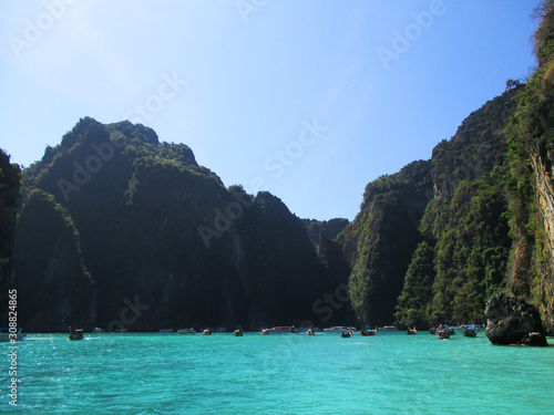 Beautiful limestone carvings off shore from Krabi with blue green water, Krabi, Thailand