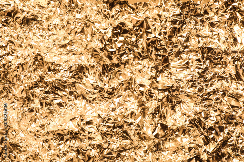 Crumpled gold foil as background, top view Crumpled gold foil as background, top view