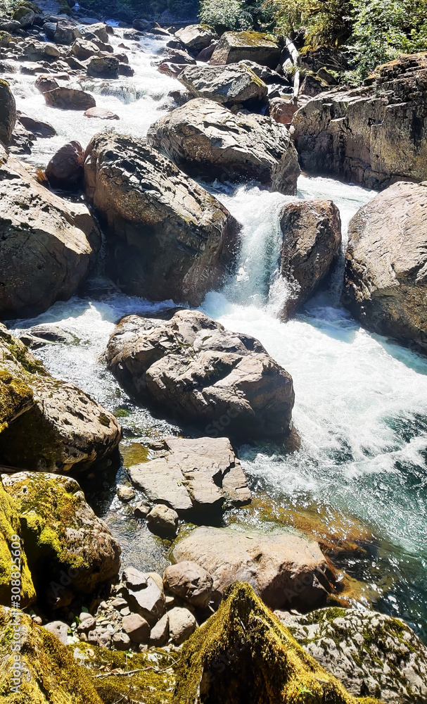 Shimmering cascades and bountiful boulders on the North Fork Sauk River in the Summertime off the Mountain Loop Highway in Silverton Washington State Snohomish County Shimmering cascades and bountiful boulders on the North Fork Sauk River in the Summertime off the Mountain Loop Highway in Silverton Washington State Snohomish County
