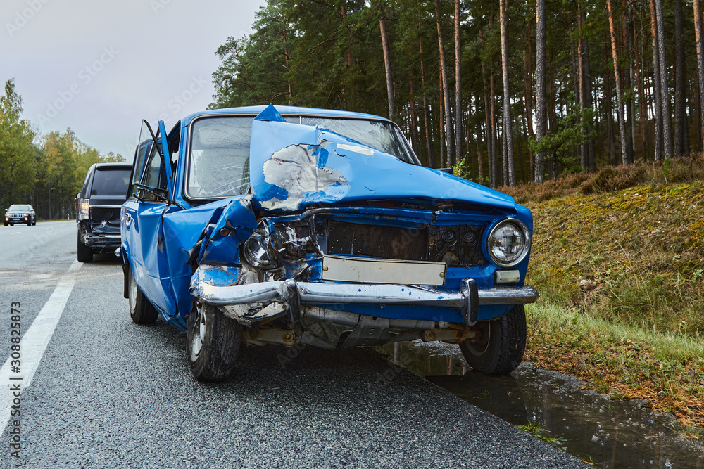 Fototapeta premium damaged old car on the highway at the scene of an accident