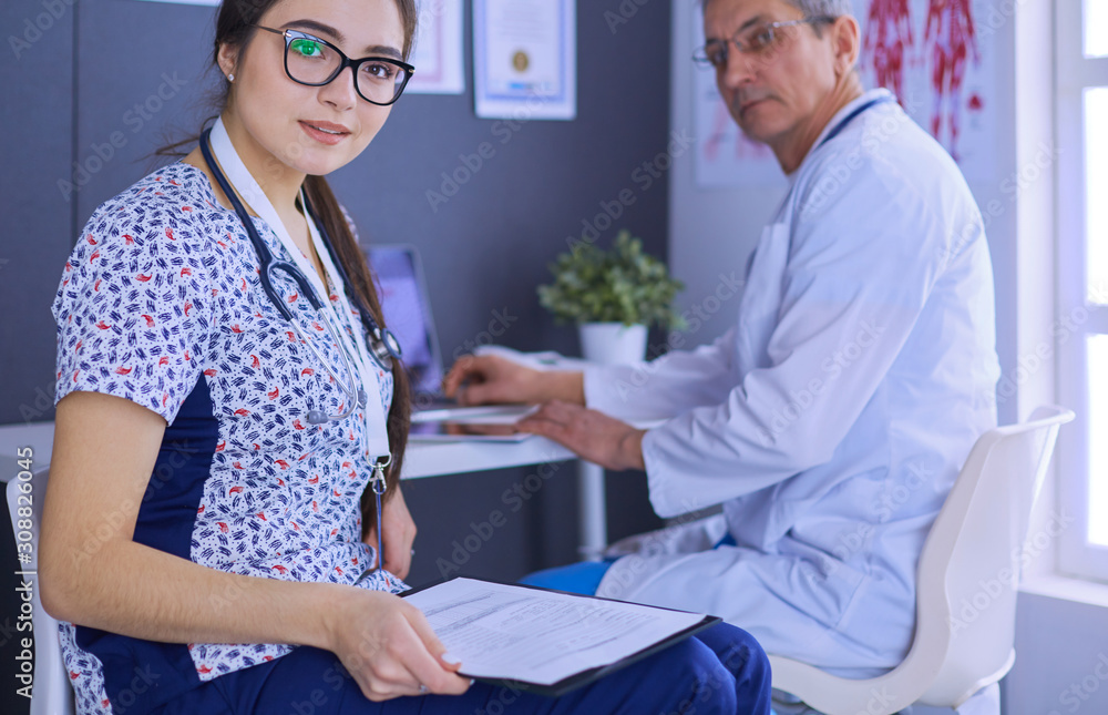 Two doctors speaking in a bright office Two doctors speaking in a bright office