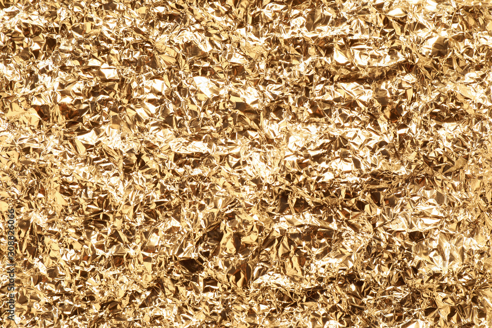 Crumpled gold foil as background, top view Crumpled gold foil as background, top view