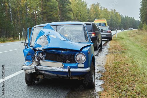 damaged old car on the highway at the scene of an accident © jteivans