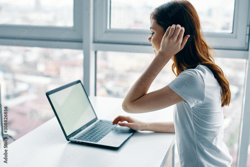 young woman working on laptop at home young woman working on laptop at home