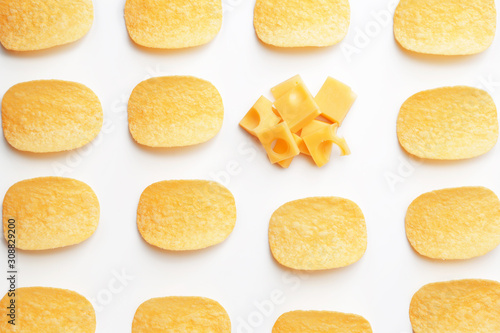 Tasty potato chips and cheese on white background