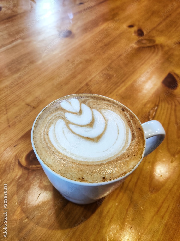 cup of coffee on wooden table cup of coffee on wooden table