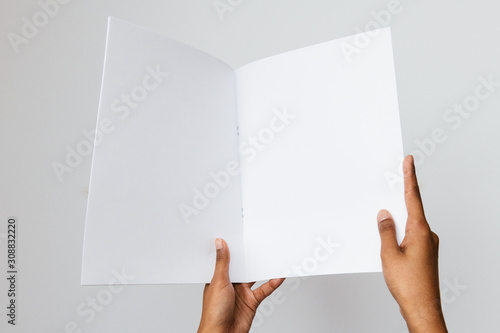 Woman of color holding a letter size or A4 brochure mockup