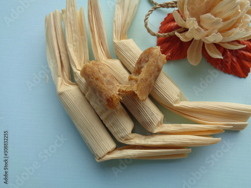 Klethik nanas, dry stir fry smash pineapple cover up with corn husk. Indonesian traditional snack, sweat snack photo