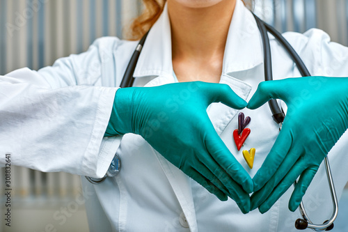 doctor shows simbols of heart through the hands folded in the shape of a heart with medical care concept, Medicine in hospital, cardiology.