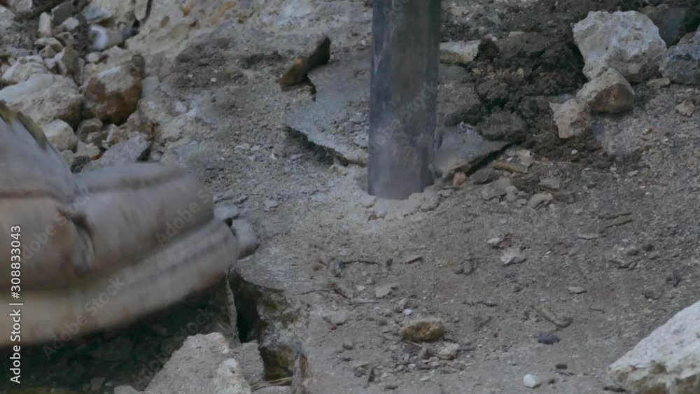 Jackhammer breaks up a concrete floor - close-up4K Jackhammer breaks up a concrete floor - close-up4K