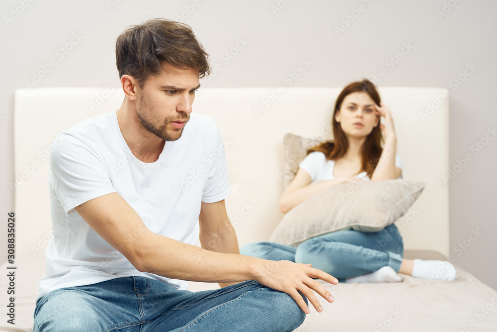 young couple sitting on sofa watching tv young couple sitting on sofa watching tv