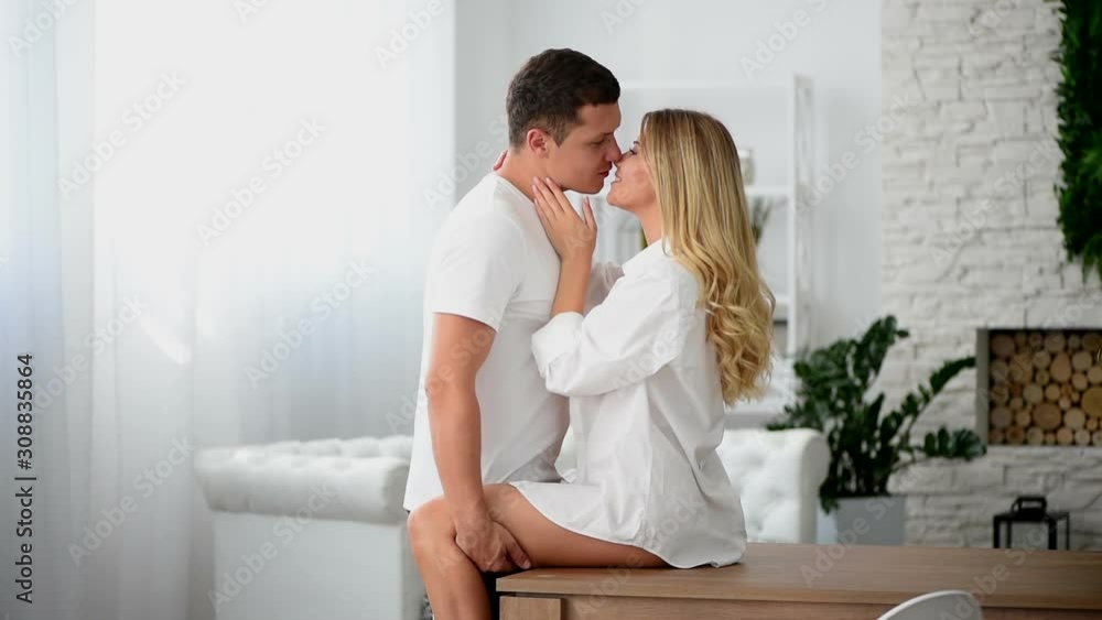 Couple of lovers are kissing on the kitchen, morning after meeting Couple of lovers are kissing on the kitchen, morning after meeting