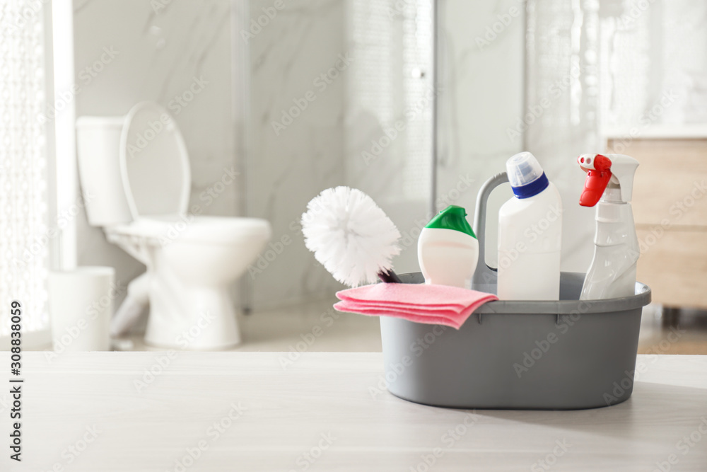 Cleaning supplies and toilet bowl in bathroom. Space for text Stock Photo