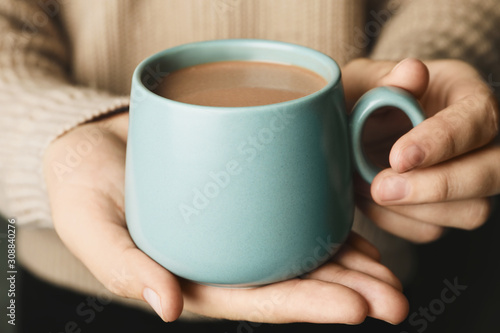 Woman holding cup of delicious hot cocoa, closeup