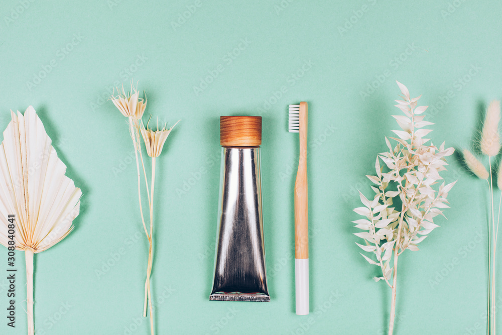 Zero waste self-care products. Bamboo toothbrush, toothpaste, tooth powder. Flat lay style.