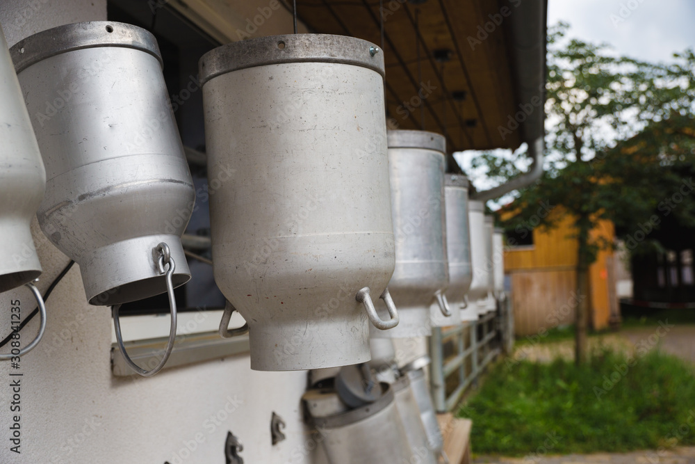 milk churns hanging outside farm for cows milk churns hanging outside farm for cows