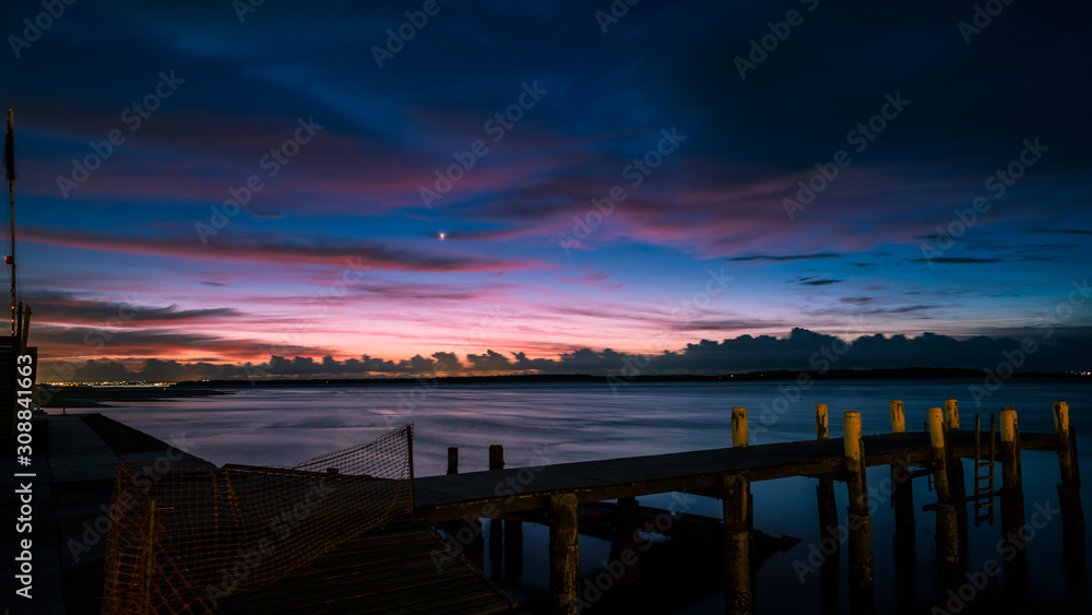 Clouds and pier at dawn
