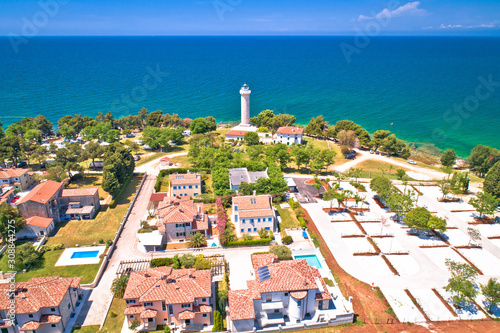 Savudrija lighthouse and turquoise crystal clear rocky beach aerial view