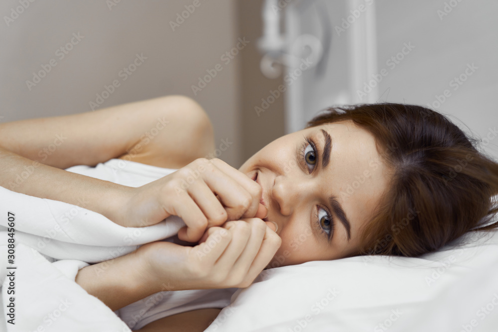 portrait of a woman lying on her bed