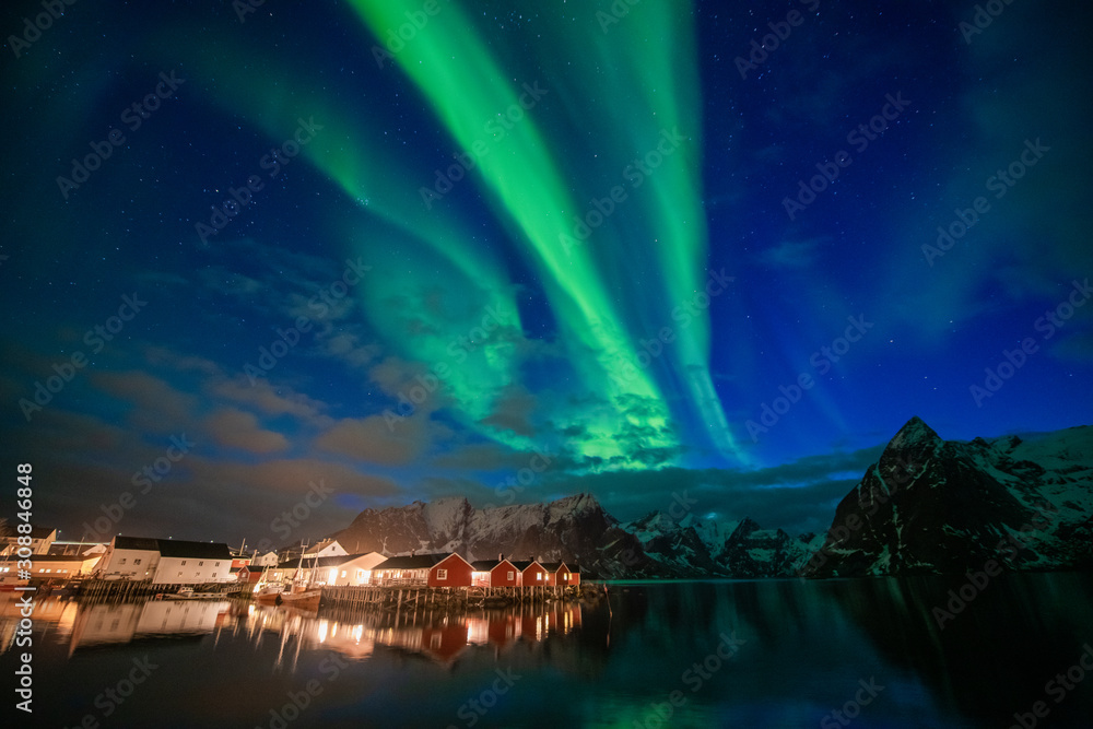 Aurora borealis on the Lofoten islands, Norway. Green northern lights above mountains. Night sky with polar lights. Night winter landscape