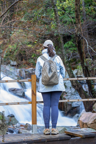 Spanish tourist woman looking a small river in the Spanish mountain Montseny