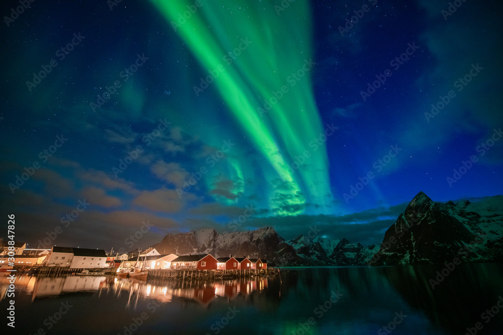Aurora borealis on the Lofoten islands, Norway. Green northern lights above mountains. Night sky with polar lights. Night winter landscape
