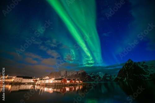 Aurora borealis on the Lofoten islands  Norway. Green northern lights above mountains. Night sky with polar lights. Night winter landscape