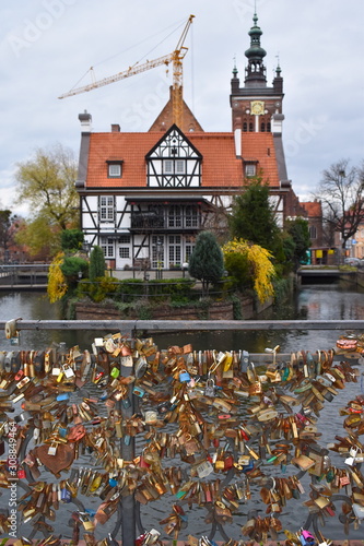 Love bridge with padlocks over Radunia canal between Kowalska and Korzenna streets in Gdansk old Town. Getting there on foot ten minutes north from Long street, close to Great mill and Hevelius square photo