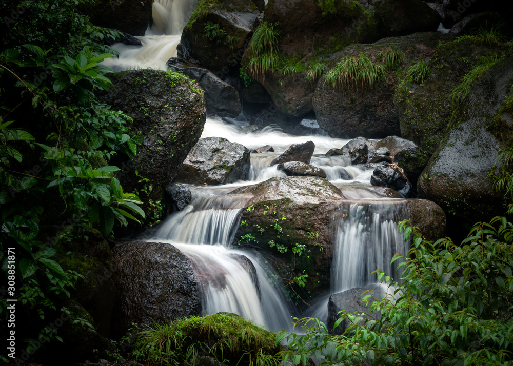 Landscape of a waterfall in an Indian forest during the peak monsoon season Landscape of a waterfall in an Indian forest during the peak monsoon season