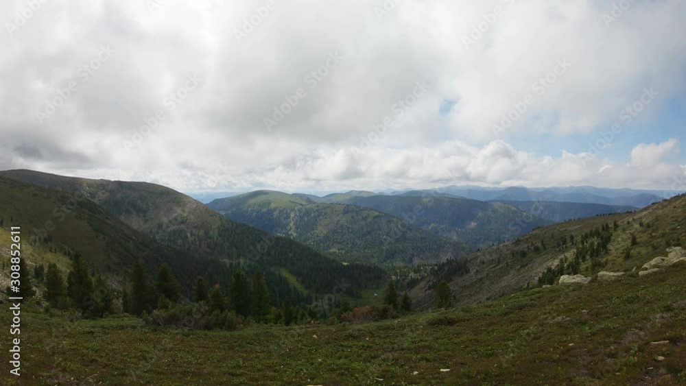 Panorama of mountain valley. View from top of the mountain. Pan. Slow motion Panorama of mountain valley. View from top of the mountain. Pan. Slow motion