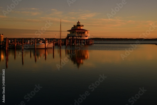 Close up on Choptank River Lighthouse during Dawn with reflection in the water photo