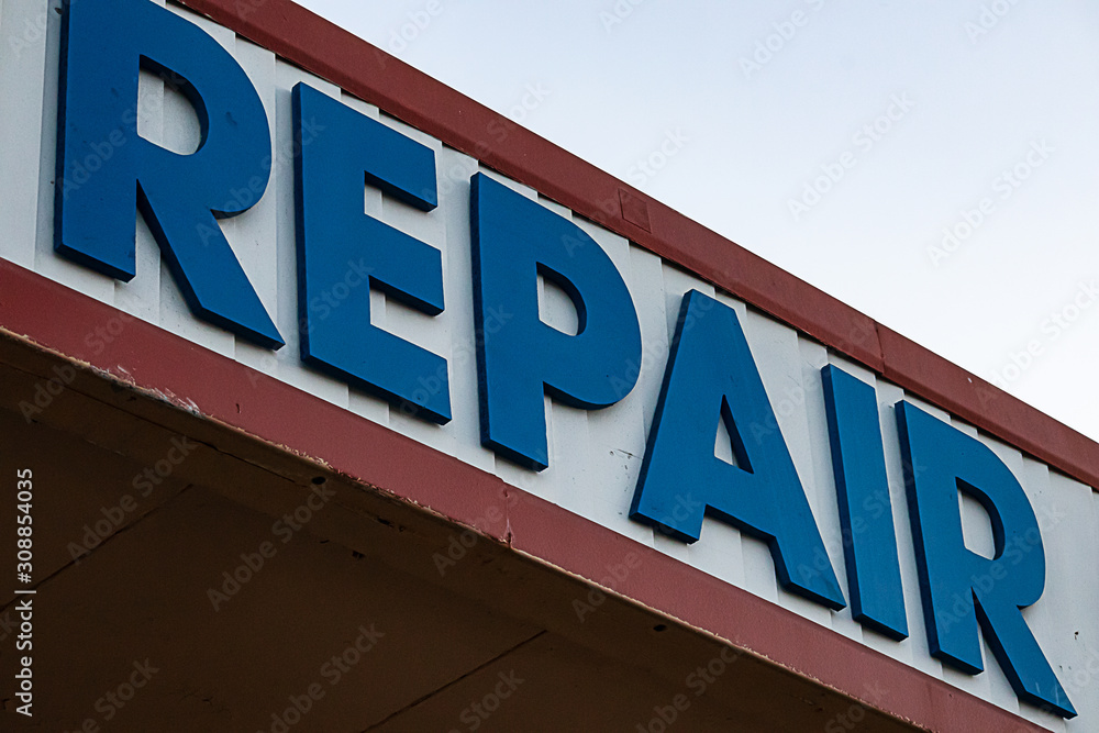 blue, red and white sign advertising repair service