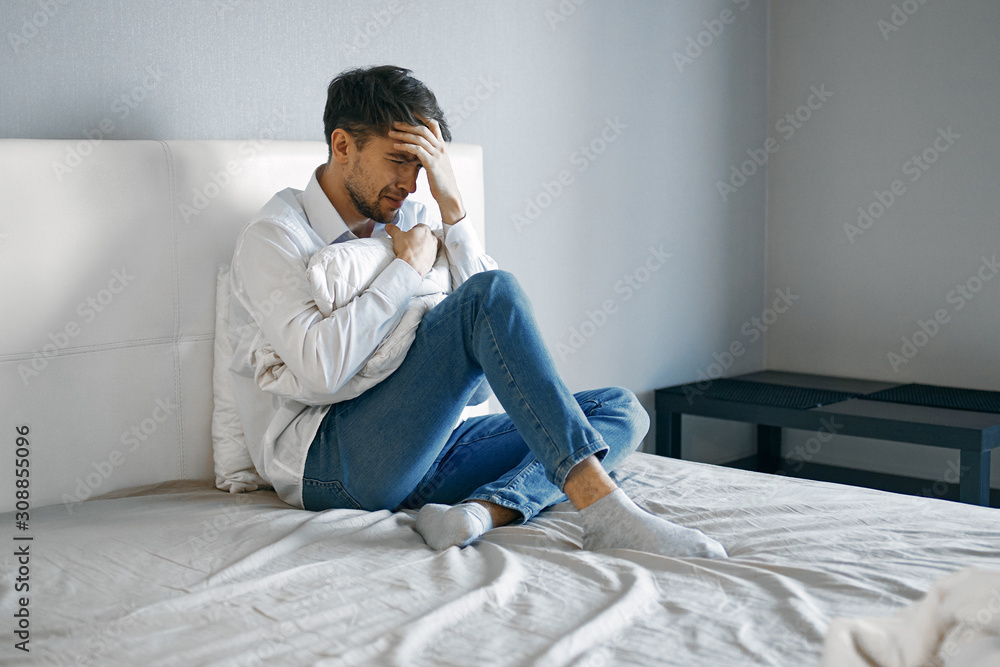 man sitting on sofa with laptop and mobile phone man sitting on sofa with laptop and mobile phone