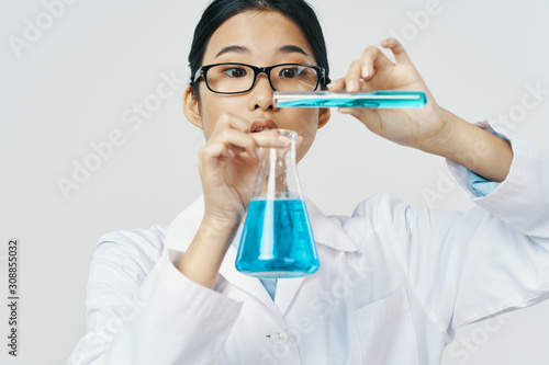 scientist in laboratory with test tubes