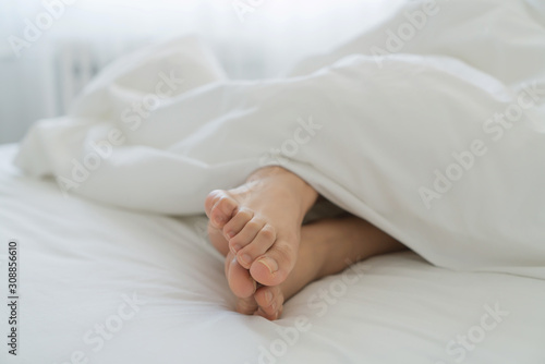 women feet on bed