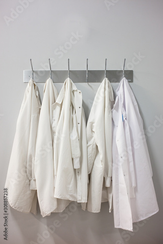 Lab coats hanging hooks at laboratory